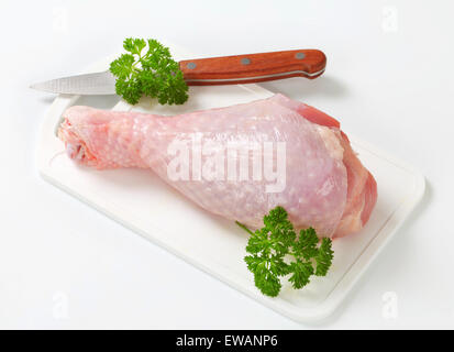 Raw turkey leg on cutting board Stock Photo