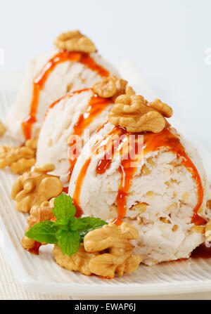 Scoops of walnut ice cream with caramel sauce Stock Photo