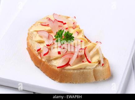 White bread with butter and chopped radishes Stock Photo