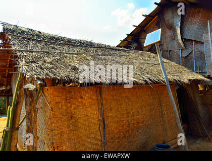A single solar panel provides basic electricity for dwelling such as this for a few lights bulbs only in a village on Inle Lake,  Burma,Southeast Asia Stock Photo