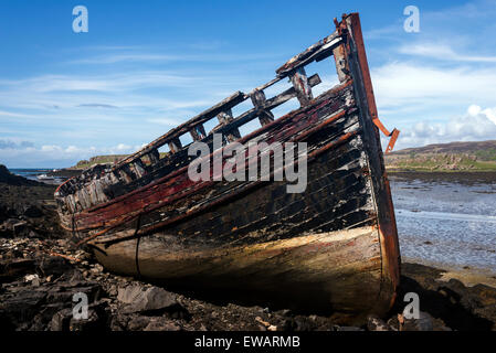 A single abandoned fishing boat at low tide on the banks of Loch a' Chumbainn Croig Isle of Mull Inner Hebrides Argyll Scotland Stock Photo