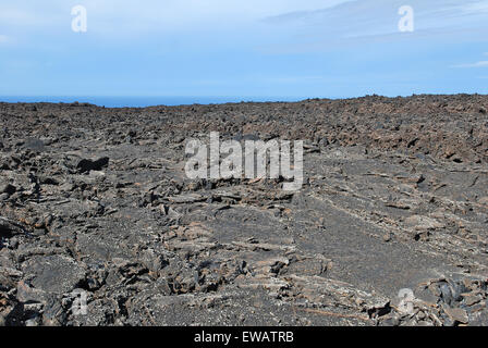 Lanzarote, Canary Islands, Spain. A lava field with mountains in the horizon, in Timanfaya Natural Park. Stock Photo