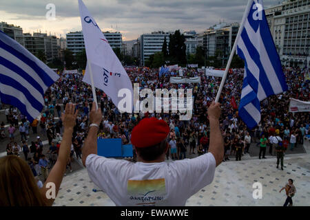 Athens, Greece. 21st June, 2015. A man waves flags of Greece and Independence Greeks party. Greeks demonstrate against austerity prior to Monday's 22nd July Eurogroup which is possible to decide if Greece remains or exits Eurozone. Credit:  Kostas Pikoulas/Pacific Press/Alamy Live News Stock Photo