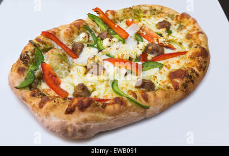 Fresh pizza closeup with italian sausage, peppers, onions, goat cheese and mozzarella toppings Stock Photo