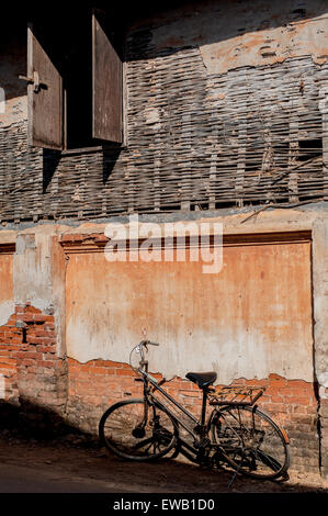 cracked brick wall and Old rusty vintage bicycle