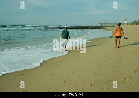 Durban, KwaZulu-Natal, South Africa, active adult couple walking on sandy beach, uMhlanga Rocks, landscape Stock Photo