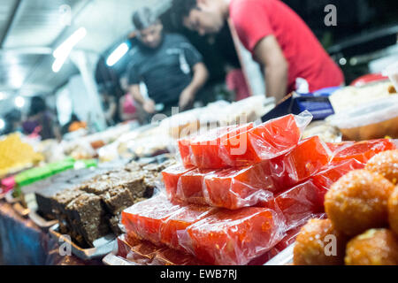 Vendors serve a customer at a food stall in a market in Bandar Baru Sentul in Kuala Lumpur, Malaysia Stock Photo