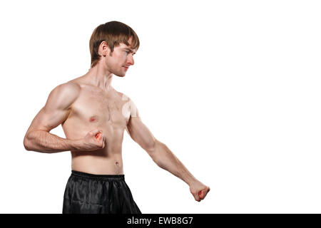The man trains kata taekwondo. Isolated on white background. The concept of masculine strength and a healthy lifestyle. Stock Photo