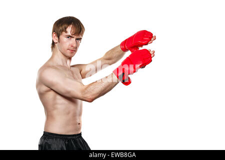 Male fighter kung fu kick to the head blocks. Isolated on white background. The concept of martial arts. Stock Photo