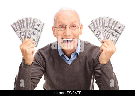 Studio shot of a joyful senior holding money in both hands and looking at the camera isolated on white background Stock Photo