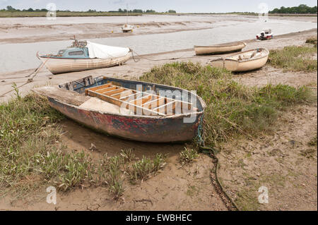 marooned sailing boat boats raised up on silty mud and sand at low tide on backwaters of estuary at he Hythe Quay Maldon Stock Photo