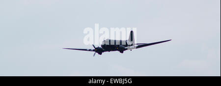 The Douglas C-47 Dakota at RAF Cosford Airshow flyby with crew waving at crowd. Stock Photo