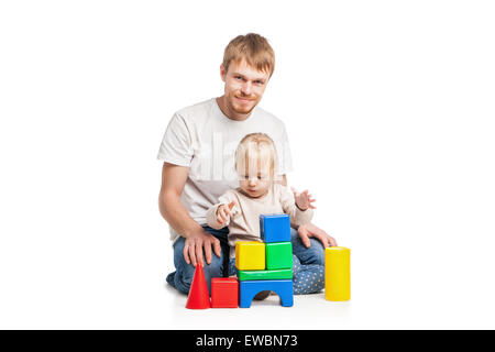 Baby girl building from toy blocks with her father Stock Photo