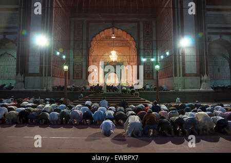 Men praying at Jama Masjid at night during Ramadan. Old Delhi, India.
