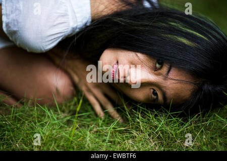 A young, pretty Asian woman in a garden in Hanoi, Vietnam. Stock Photo