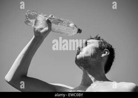 Photo of a man who's face is covered with water. Beautiful sky in the background. Stock Photo