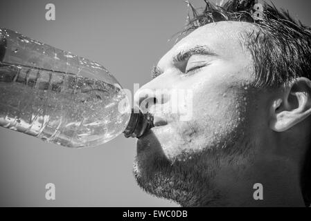 Photo of a man who's face is covered with water. Beautiful sky in the background. Stock Photo