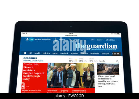 Reading the internet edition of the Guardian online newspaper on an Apple iPad Air, UK Stock Photo