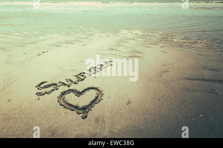 text an drawing on the beach in the sand Stock Photo