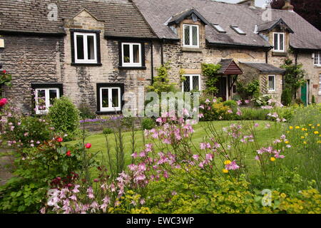 A row of traditional stone built cottages in Castleton village, PEak District National PArk, Derbyshire, UK - summer Stock Photo