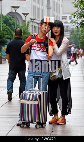 selfie stick photo attractive beautiful young  Visitors at Nanjing Road. Main shopping street of Shanghai. China Stock Photo