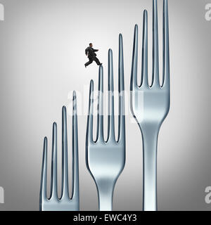 Healthy lifestyle challenge and fitness through exercise and eating health food as an overweight obese person running up a group of dinner forks as a symbol and icon of losing wieght with physical training and diet plan. Stock Photo