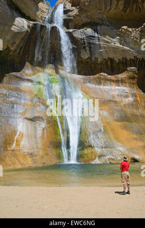 Man contemplating Lower Calf Creek Falls, Grand Staircase-Escalante National Monument, Utah, U.S.A Stock Photo