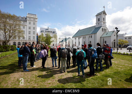 tourists on walking tour in austurvollur public square Reykjavik iceland Stock Photo