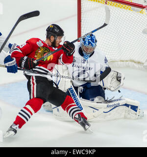 Chicago, IL, USA. 15th June, 2015. Chicago, Illinois, U.S. - Blackhawk #19 Jonathan Toews falls into Lightning Goaltender #30 Ben Bishop during the National Hockey League Stanley Cup Final game between the Chicago Blackhawks and the Tampa Bay Lightning at the United Center in Chicago, IL. Mike Wulf/CSM/Alamy Live News Stock Photo