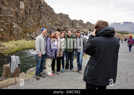 tourists pose for a photo in Almannagja fault line in the mid-atlantic ridge north american plate Thingvellir national park