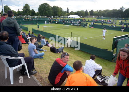 Wimbledon, London, UK. 22nd June, 2015. Bank of England Sports Grounds Roehampton London England 22nd June 2015. Spectators enjoying Wimbledon qualifying. The qualifying competition for The Championships began today - a week before the main event. there is no single 'winner' of Qualifying, instead the players who win all three rounds - 16 in the Gentlemen's Singles and 12 in the Ladies' Singles - will progress, along with four pairs in each of the Ladies' and Men's Doubles events. Credit:  mainpicture/Alamy Live News Stock Photo