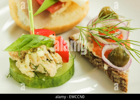 Mini canapes - Colorful fresh snacks on the white plate. Stock Photo