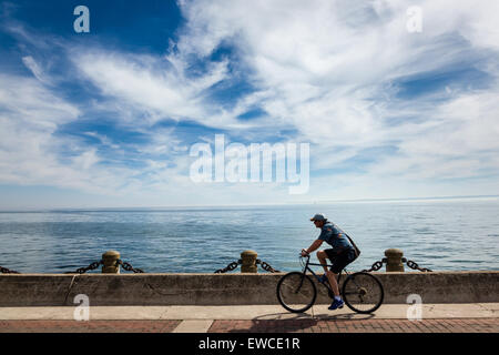 Lone male cyclist on the waterfront pathway in Burlington, on Lake Ontario Stock Photo