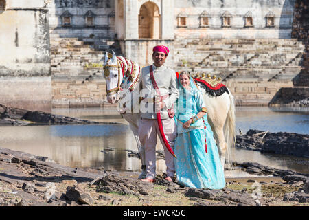 Marwari Horse. Dominant white horse decorated in gold, silver and jewels standing next to a couple in traditional dress. Chittor Stock Photo