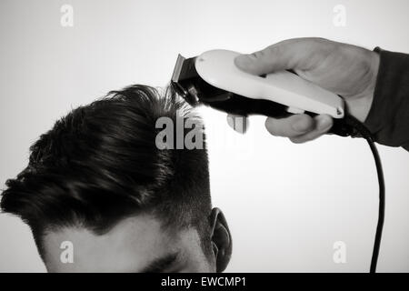 close up shot of man getting his hair cut Stock Photo