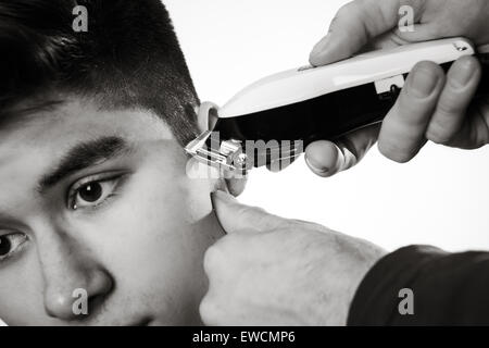 close up shot of man getting his hair cut Stock Photo