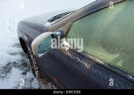 covered with frost frozen winter car on a country road Stock Photo