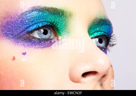 Closeup shot of shining holiday spangled female eye makeup Stock Photo