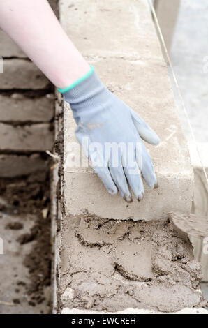 How To Build A Brick Wall. Bricklayer Hand In Masonry Gloves ...