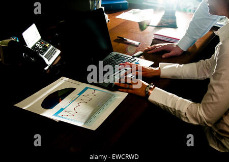 man and woman executives working on laptop. Stock Photo