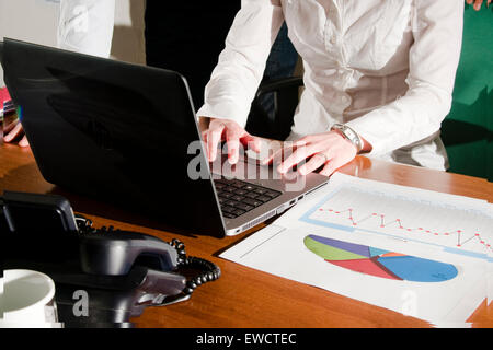 man and woman executives working on laptop. Stock Photo