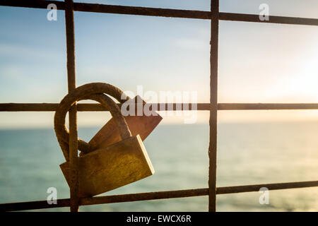 Rusty love locks hanging on the fence as a symbol of loyalty and eternal love Stock Photo