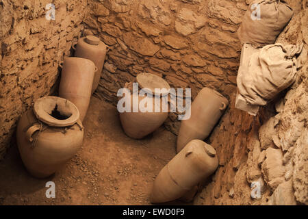 Old crocks stands in stone cellar interior Stock Photo