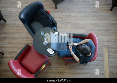 Overhead view of man using a laptop computer Stock Photo