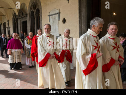 Catholic clergy with Maltese Cross in procession, Basilica of San Lorenzo, Florence, Italy Stock Photo