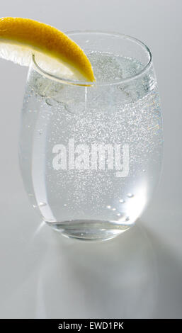 Sparkling water in  glass with lemon Stock Photo