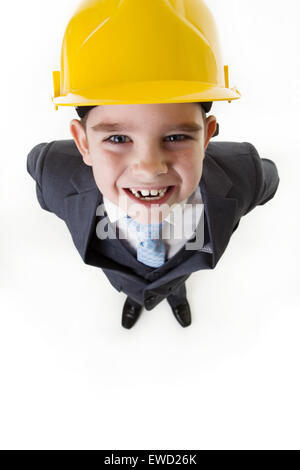 looking down on a happy young boy wearing a hard hat smiling Stock Photo