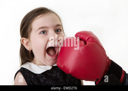 young girl getting hit in the face by someone wearing a boxing glove Stock Photo