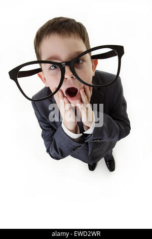 looking down at a young boy wearing large funny glasses wearing a business suit Stock Photo