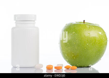 Natural green apple and various pills on white background Stock Photo